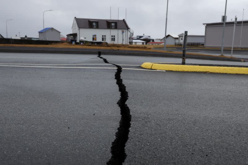Cracks emerge on a road due to volcanic activity near a police station, in Grindavik