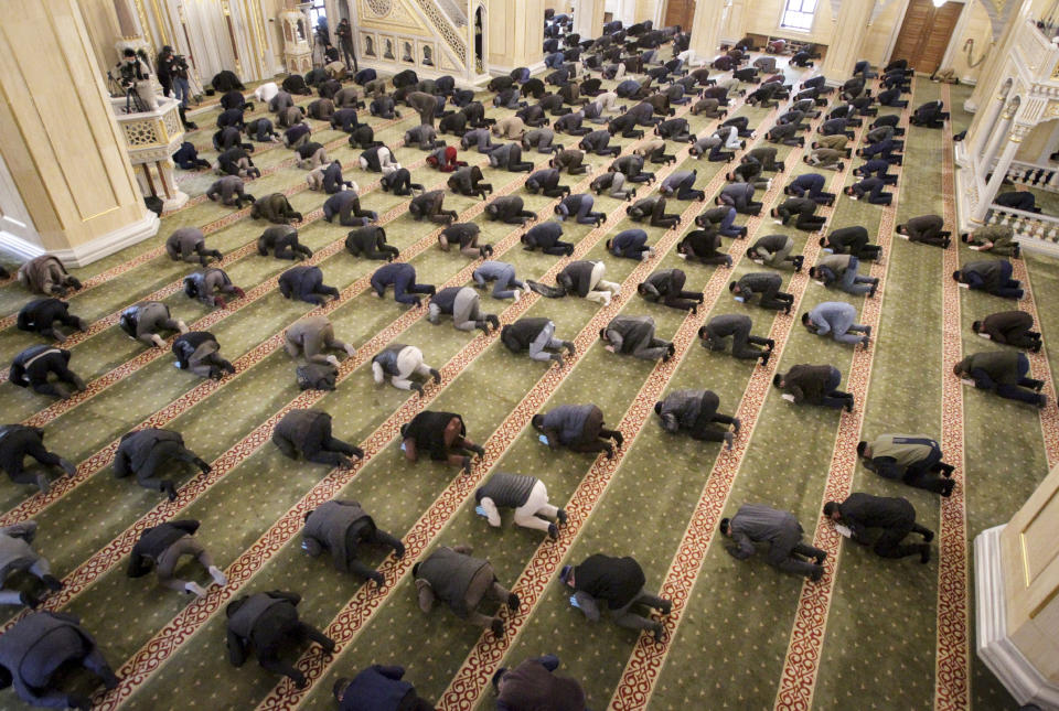 Muslims, some wearing face masks and gloves to protect against coronavirus, observe social distancing guidelines as they attend Eid al-Fitr prayers in Grozny, Russia, Sunday, May 24, 2020. Muslims worldwide are marking a muted religious festival of Eid al-Fitr, the end of the fasting month of Ramadan, a usually joyous three-day celebration that has been significantly toned down due to the new coronavirus outbreak. (AP Photo/Musa Sadulayev)