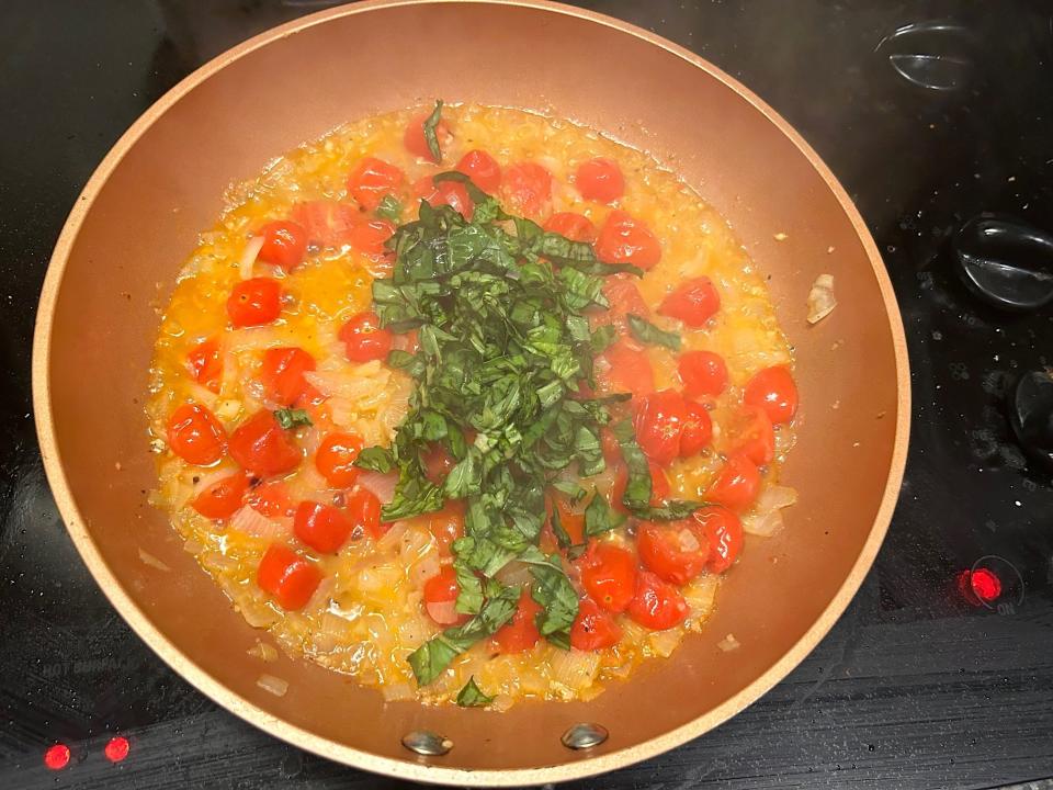 Adding basil to pan for Gordon Ramsay's 10-minute scampi