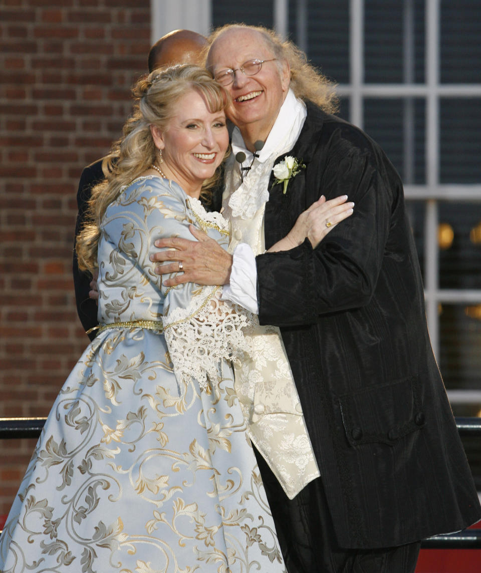 FILE – In this July 3, 2008, file photo, historical re-enactors Ralph Archbold, right, who portrays Benjamin Franklin, and Linda Wilde, left, who portrays Betsy Ross, smile to the crowd after exchanging wedding vows while dressed in Colonial-era formalwear, during their real-life wedding ceremony in front of Independence Hall in Philadelphia. Archbold, who portrayed Franklin in Philadelphia for more than 40 years, died Saturday, March 25, 2017, at age 75, according to the Alleva Funeral Home in Paoli, Pa. (AP Photo/Tom Mihalek, File)