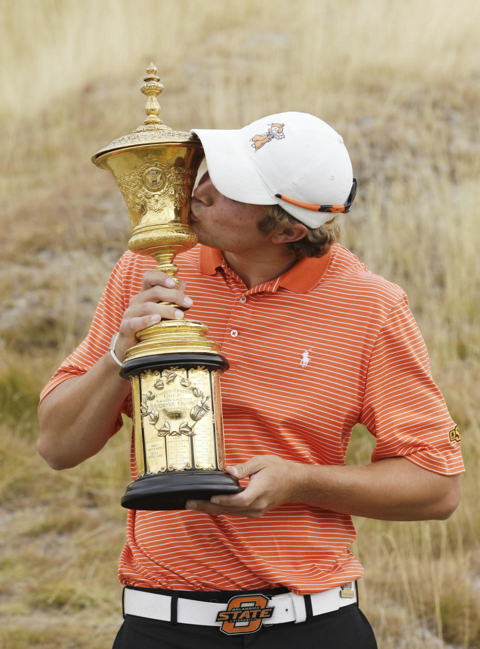 FILE - Peter Uihlein kisses the Havemeyer Trophy after Uihlein beat David Chung 4 and 2 in the final round of the U.S. Amateur golf tournament, Sunday, Aug. 28, 2010, at Chambers Bay in University Place, Wash. Uihlein has become the face of how quickly Saudi-funded LIV Golf can change fortunes. (AP Photo/Ted S. Warren, File)