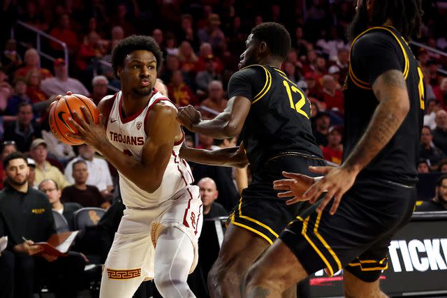 <p>Katelyn Mulcahy/Getty </p> Bronny James (left) makes his USC basketball debut on Dec. 10, 2023.