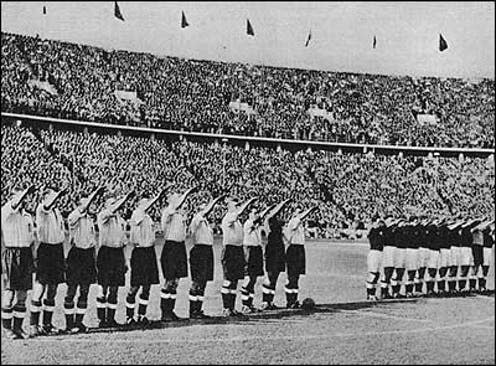 <span class="caption">England's players were instructed to perform the Nazi salute during the German national anthem.</span>