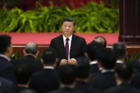 Chinese President Xi Jinping adjusts his jacket as he attends a dinner reception at the Great Hall of the People on the eve of the National Day holiday in Beijing, Friday, Sept. 30, 2022. (AP Photo/Ng Han Guan)