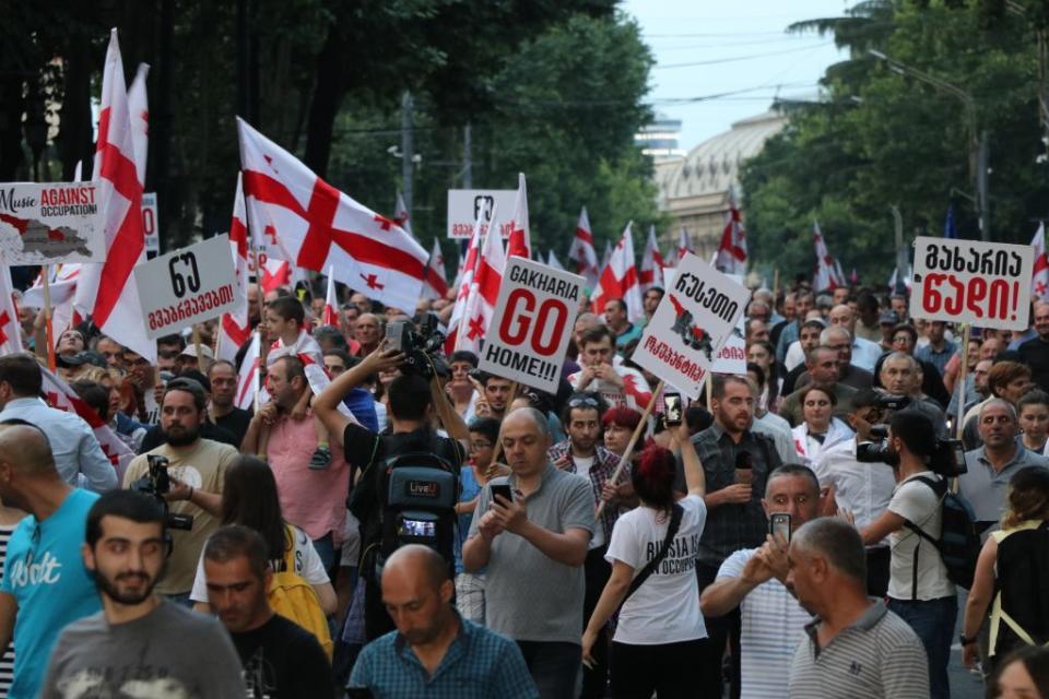 Demonstrators march on the 17th day of protests over a Russian lawmaker's visit to Georgia's parliament on July 6, 2019, in Tbilisi, Georgia. (Davit Kachkachishvili/Anadolu Agency/Getty Images)