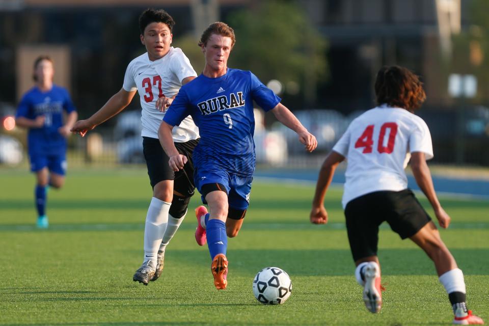 Washburn Rural senior midfielder Joe Morse dribbles around Shawnee Heights defenders in the first half of the Junior Blues game on Aug. 31.