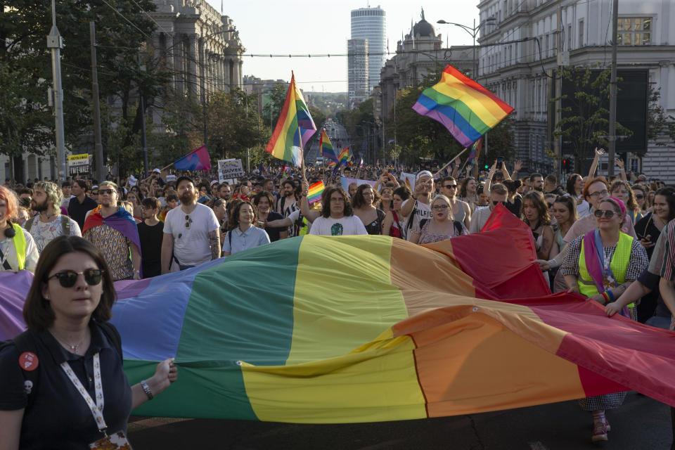 FILE - People hold a large Rainbow flag as they take part in a Pride march in Belgrade, Serbia, Saturday, Sept. 9, 2023. Greece is becoming the first majority-Orthodox Christian nation to legalize same-sex marriage. At least for the near future, it will be the only one. The Eastern Orthodox leadership, despite lacking a single doctrinal authority like a pope, has been unanimous in opposing recognition of same-sex relationships. (AP Photo/Marko Drobnjakovic, File)