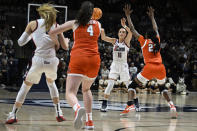 UConn guard Nika Muhl (10) passes to guard Paige Bueckers, left, in the first half of a second-round college basketball game against Syracuse in the NCAA Tournament, Monday, March 25, 2024, in Storrs, Conn. (AP Photo/Jessica Hill)