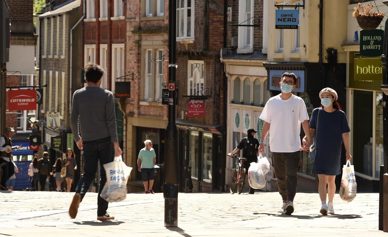 People walk in the sunshine in Durham, north east England, where 10 Downing Street special advisor Dominic Cummings is alleged to have travelled to, from London, while the nation was under lockdown to curb the spread of COVID-19. - British Prime Minister Boris Johnson on Monday failed to draw a line under a scandal over his top aide Dominic Cummings allegedly breaching coronavirus rules as pressure mounted on the Brexit mastermind to go. Cummings is alleged to have left his London home to stay with his parents in Durham, northeast England, while suffering symptoms of COVID-19, British newspapers the Daily Mirror and The Guardian said. (Photo by Oli SCARFF / AFP) (Photo by OLI SCARFF/AFP via Getty Images)