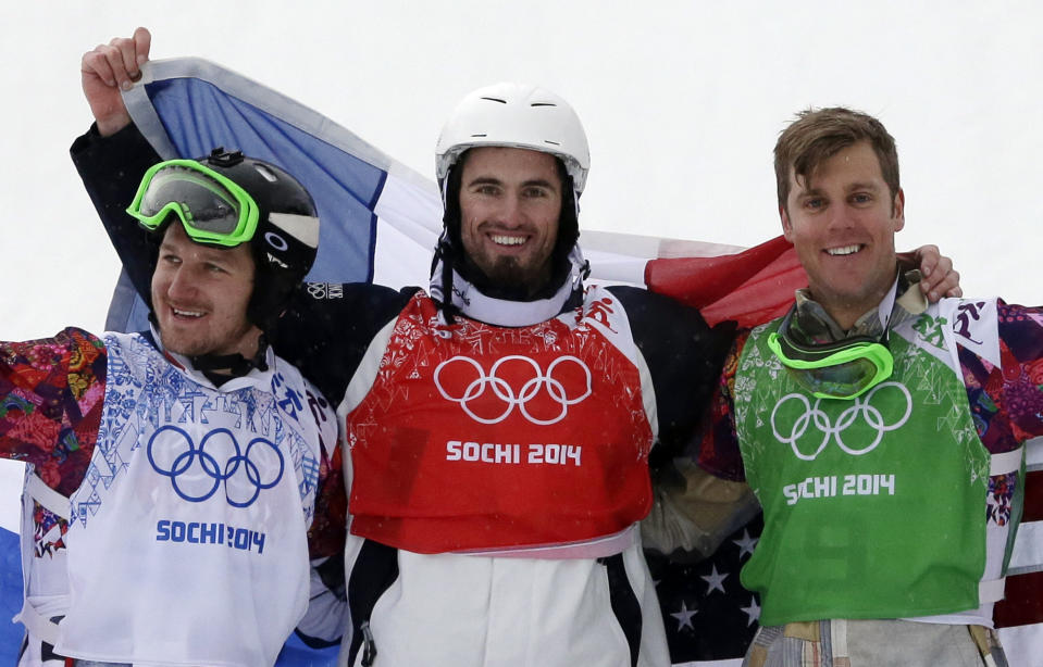 France's Pierre Vaultier, center, celebrates his gold medal with silver medalist Nikolai Olyunin of Russia, left, and bronze medalist Alex Deibold of the United States after the men's snowboard cross final at the Rosa Khutor Extreme Park, at the 2014 Winter Olympics, Tuesday, Feb. 18, 2014, in Krasnaya Polyana, Russia. (AP Photo/Andy Wong)