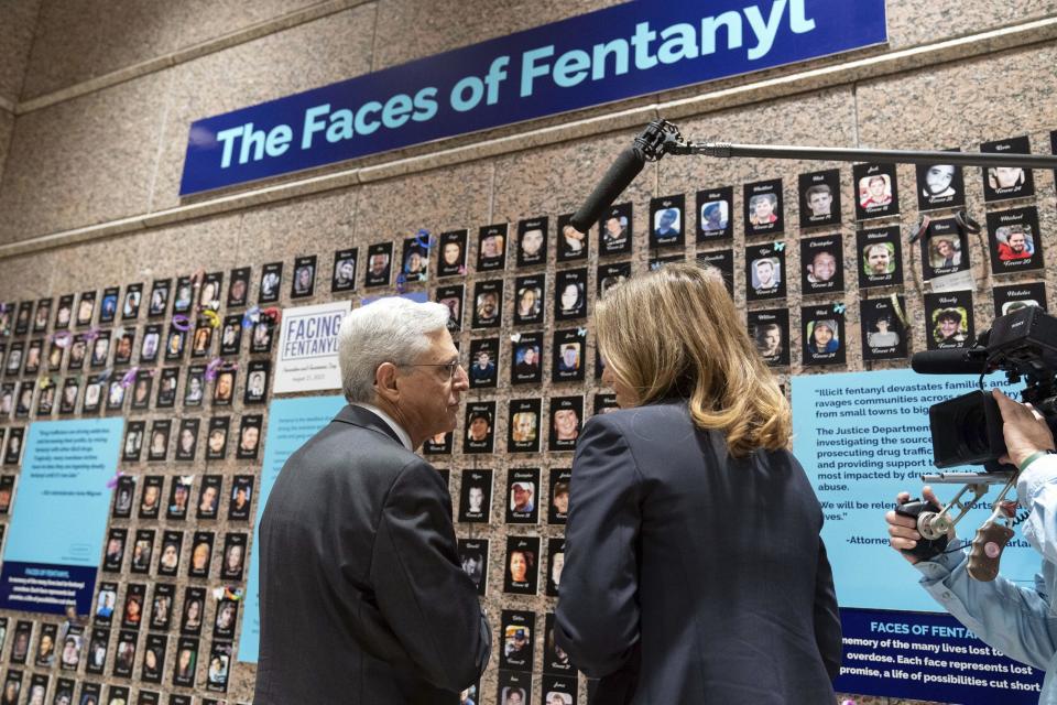 Attorney General Merrick Garland accompanied by U.S. Drug Enforcement Administration Administrator Anne Milgram, looks at photographs of people who had died from drugs during the Second Annual Family Summit on Fentanyl at DEA Headquarters in Washington, Tuesday, Sept. 26, 2023. / Credit: Jose Luis Magana / AP