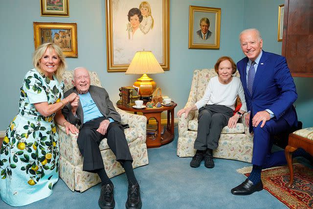 Adam Schultz/AP/Shutterstock Jimmy and Rosalynn Carter pose inside their Plains, Georgia, home during a visit from Joe and Jill Biden in 2021