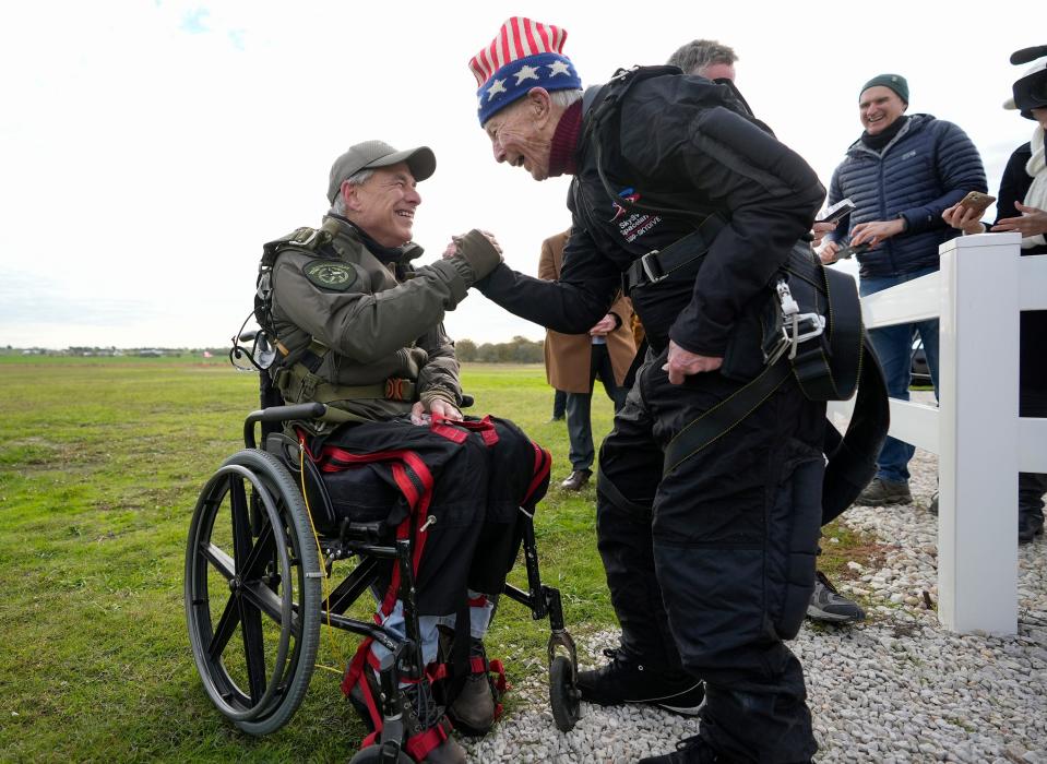 Gov. Greg Abbott celebrates with 106-year-old Al Blaschke after they both skydived at Skydive Spaceland in Fentress on Monday November 27, 2023.