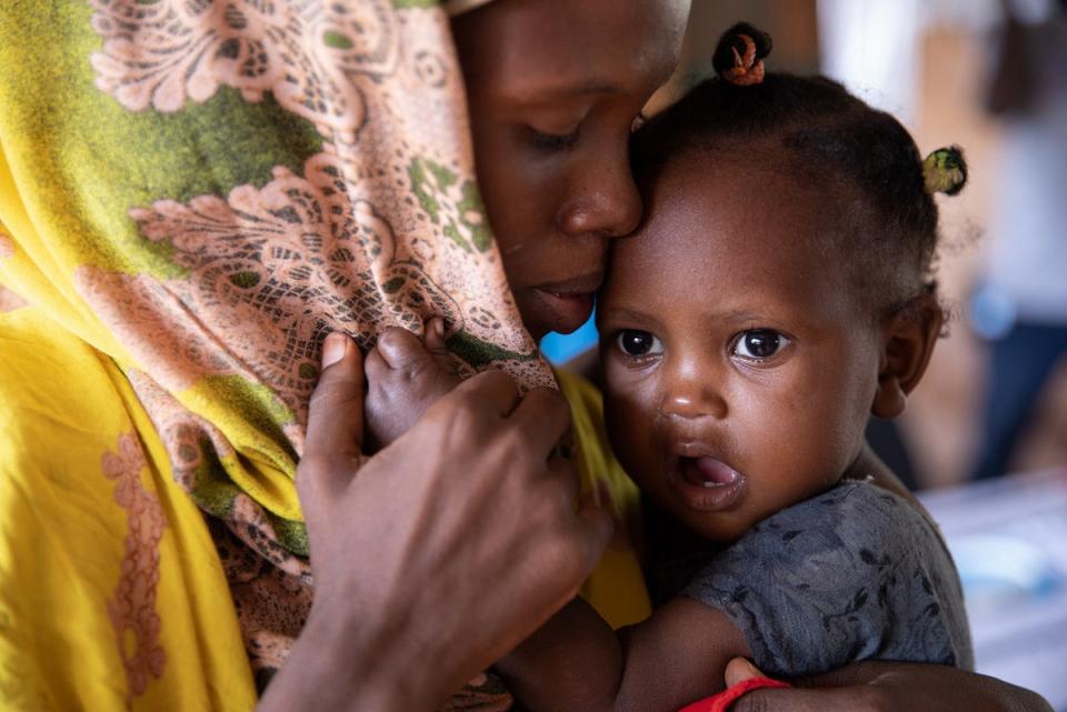 Baby Mushtaq is comforted by her mother Ayan at the WFP-funded Kabasa health centre. She is there to have her MUAC measured, as well as her height and weight recorded in order to assess her malnutrition status (WFP/Samantha Reinders)