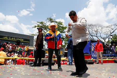 Venezuela's President Nicolas Maduro dances during a campaign rally in Charallave, Venezuela May 15, 2018. REUTERS/Carlos Garcia Rawlins