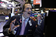 Trader Gregory Rowe works on the floor of the New York Stock Exchange, Friday, Dec. 13, 2019. After months of waiting, markets had a muted reaction to news Friday that the US and China had reached an initial deal on trade. (AP Photo/Richard Drew)