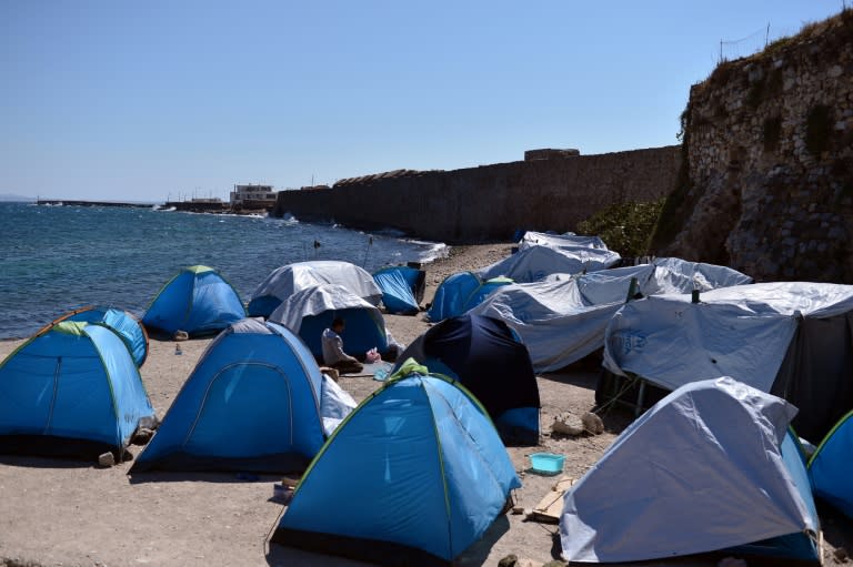 A man prays among tents at the Souda migrant camp on the Greek island of Chios, on September 28, 2016