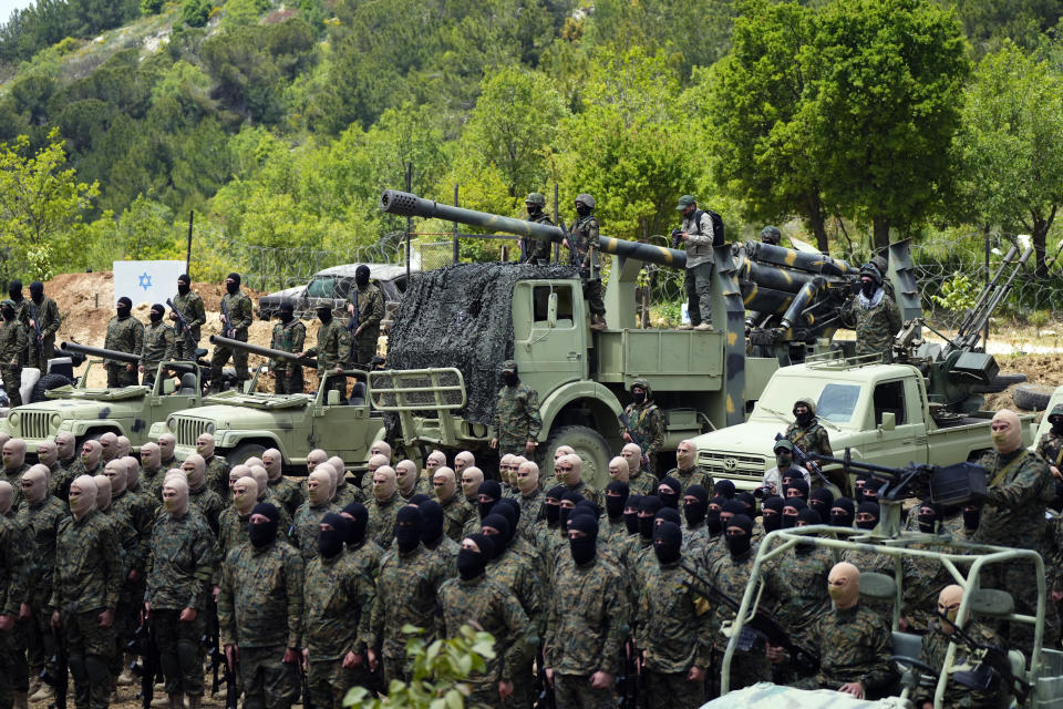 FILE - Fighters from the Lebanese militant group Hezbollah carry out a training exercise in Aaramta village in the Jezzine District, southern Lebanon, Sunday, May 21, 2023. Thousands of fighters from Iran-backed groups in the Middle East are offering to come to Lebanon to join the militant Hezbollah group in its fight with Israel. (AP Photo/Hassan Ammar, File)