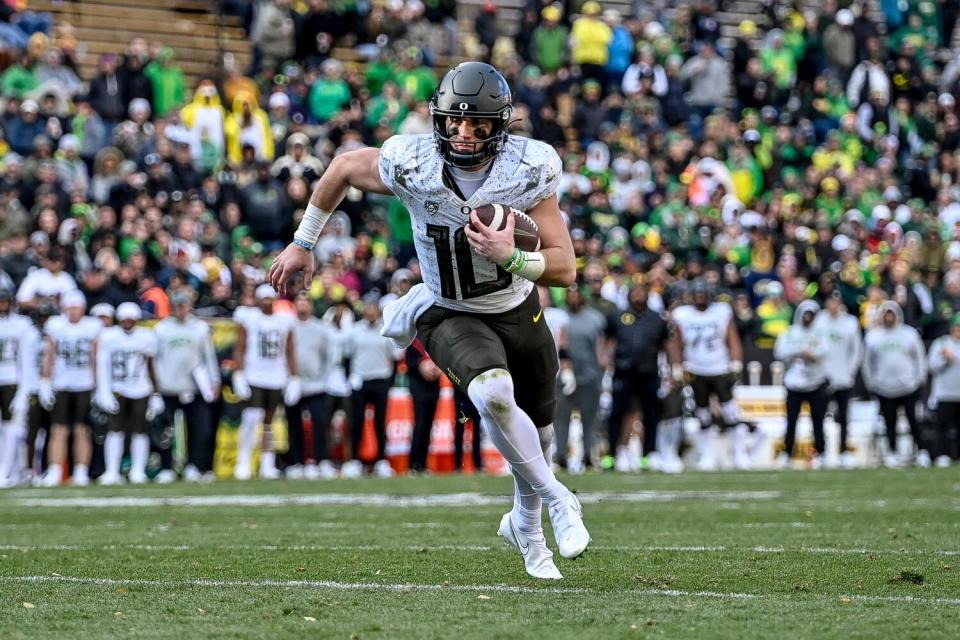 Oregon quarterback Bo Nix runs for yardage.