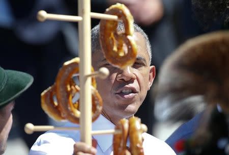 U.S. President Barack Obama looks at pretzels as he visits Kruen, southern Germany, June 7, 2015. REUTERS/Hannibal Hanschke