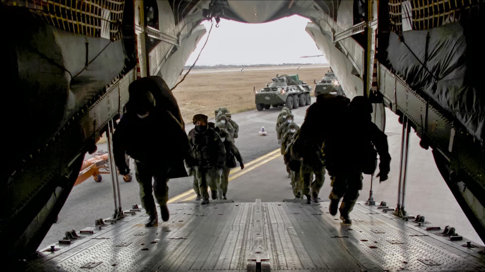 This photo made from the footage provided by Russian Defense Ministry press service on in Tuesday, Nov. 10, 2020 shows Russian peacekeepers taking on a board of military plane in unknown place in Russia. Scores of Russian peacekeepers were heading to Nagorno-Karabakh on Tuesday morning, hours after Armenia and Azerbaijan agreed to halt the fighting over the separatist region in a pact signed with Moscow which envisions the deployment of nearly 2,000 Russian peacekeepers and territorial concessions. (Russian Defense Ministry Press Service via AP)