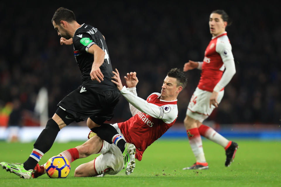 Laurent Koscielny of Arsenal tackles Luka Milivojevic of Crystal Palace