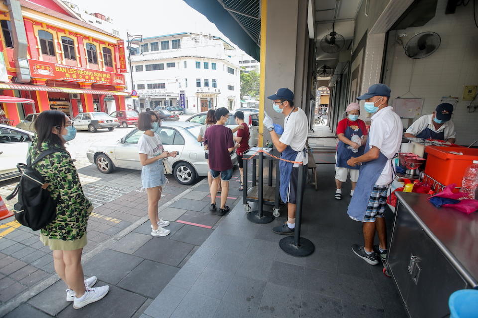 Customers maintaining social distance at the famous Funny Mountain Soya Beancurd. — Picture by Farhan Najib