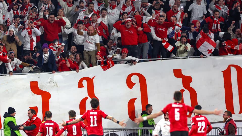 Georgia's players celebrate after winning Euro 2024 play-off final against Greece. - Giorgi Arjevandidze/AFP/Getty Images