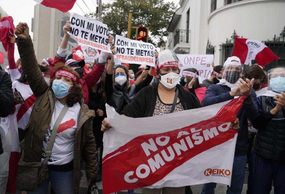 Supporters of presidential candidate Keiko Fujimori protest alleged election fraud, outside the site where the votes are being counted, in Lima, Peru, Tuesday, June 8, 2021, two days after the presidential runoff between Fujimori and rival candidate Pedro Castillo. (AP Photo/Martin Mejia)