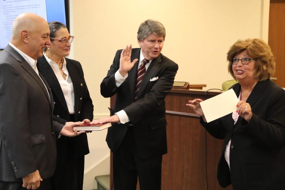 Franklin Lakes outgoing Mayor Frank Bivona and wife Maureen Bivona hold Bible for swearing in of Charles Kahwaty as new mayor by Oakland Mayor Linda Schwager. Bivona did not seek reelection after 12 years in office.