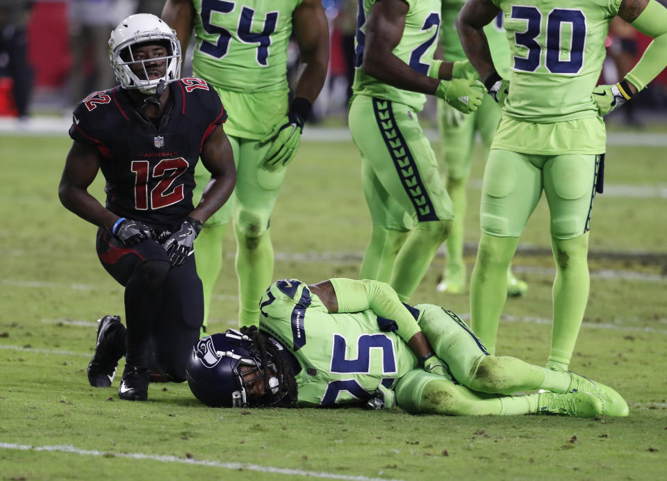 Seattle Seahawks cornerback Richard Sherman (25) lies on the turf after suffering an injury against the Cardinals. (AP)