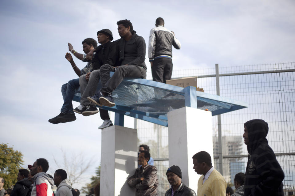 African migrants listen to speakers during a protest in Lewinsky park in Tel Aviv, Israel,Tuesday, Jan. 7, 2014. The migrants, some of whom are menial laborers in Israel, have been on a three-day strike. About 60,000 African migrants, mostly from Sudan and Eritrea, have trekked through Egypt and other Muslim countries to reach Israel in recent years. Some are fleeing violence or oppression in their home countries while others are seeking better economic opportunities. (AP Photo/Ariel Schalit)