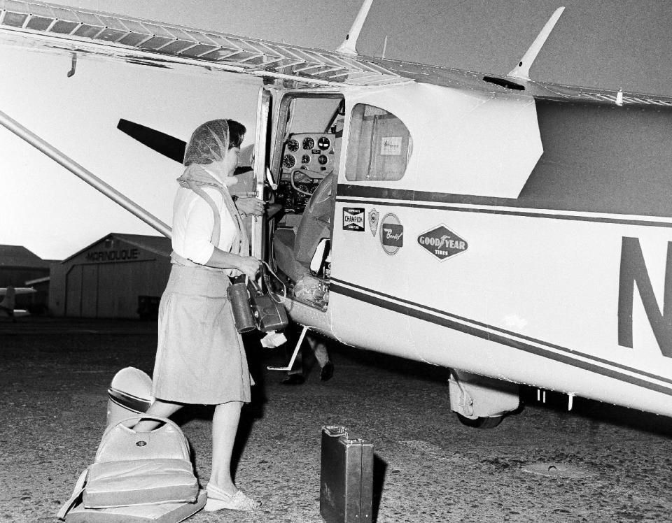 FILE - This photo made in November, 1964, shows Jerrie Mock preparing to board her single-engine propeller plane at Manila Airport, on her way for Guam during a solo flight around the world. Fifty years ago Mock became the first woman to fly solo around the world. (AP Photo/Marcelino Roxas)