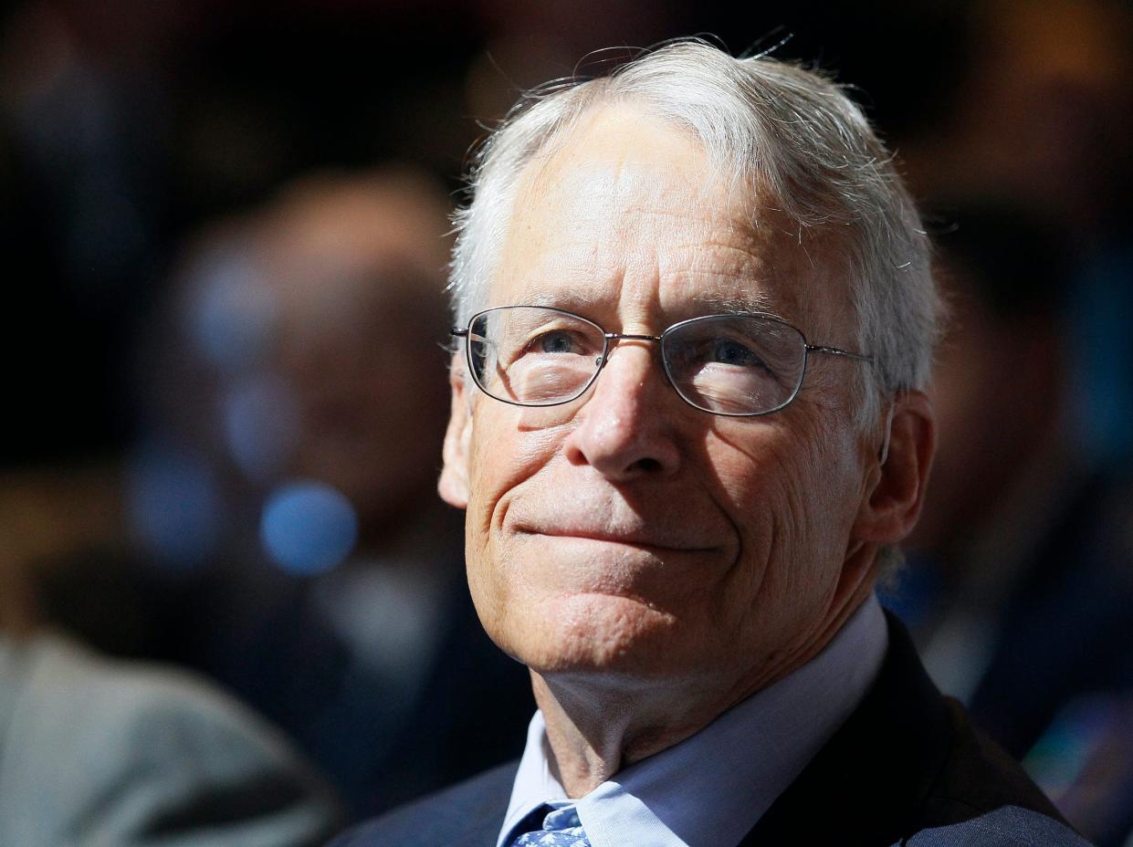 Rob Walton, former Walmart chairman, looks into distance during Walmart meeting