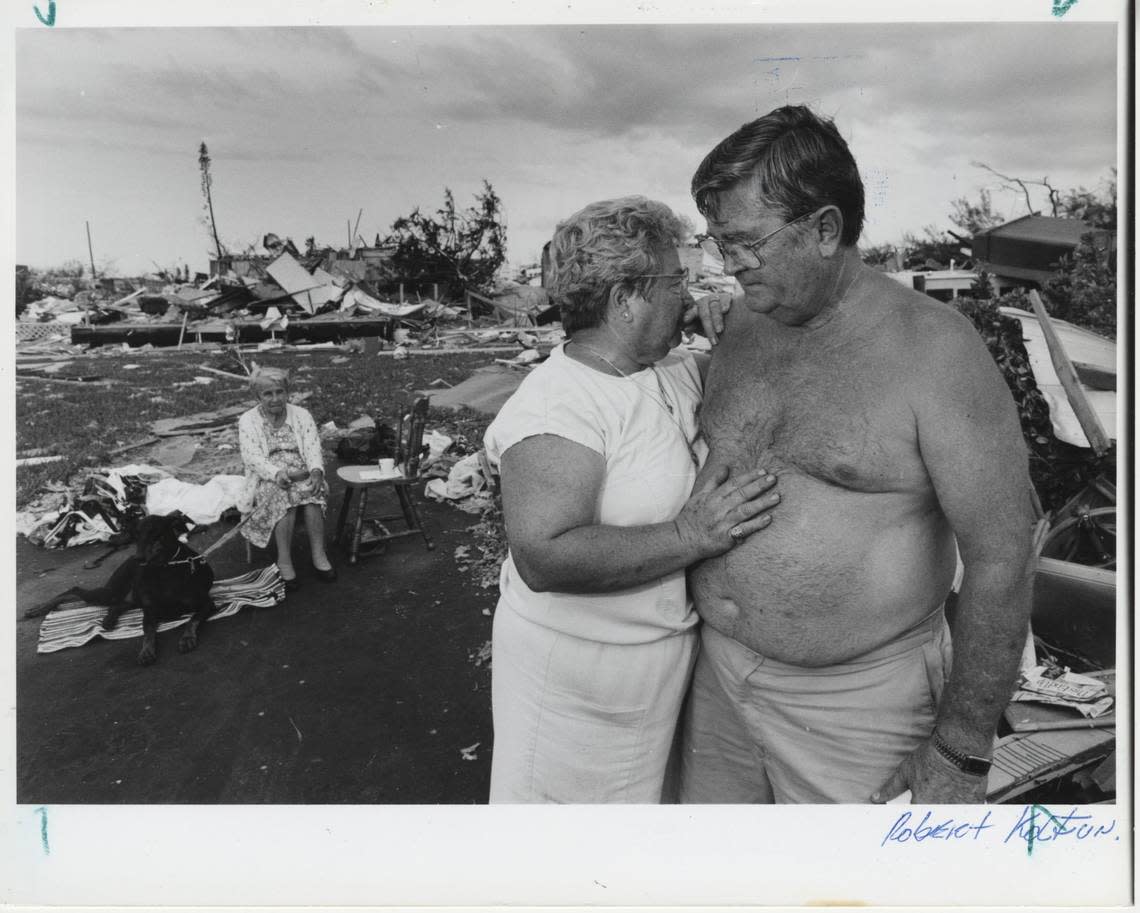 Jorena Martini (sitting in the background), born in 1896, survived the devastation of San Francisco in 1906, the earthquake that hit Oakland in 1989 and then Hurricane Andrew. She witnesses the sadness of Kauline, who embraces her husband Bill Griscom as they contemplate the ruins of their home in the Kendall area.