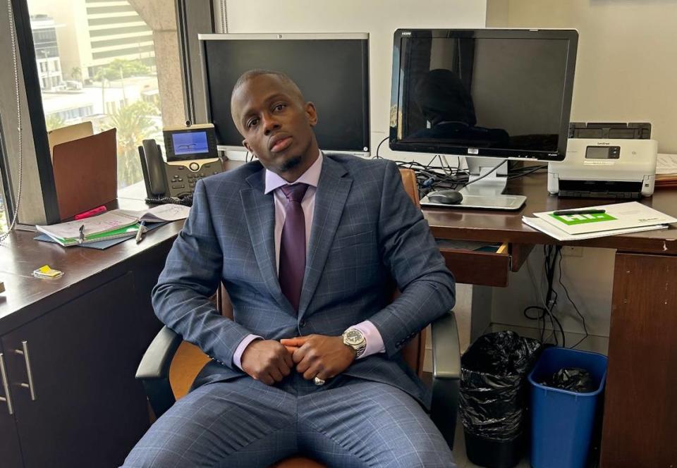 Emmanuel Jean, who was released from prison 16 years after being wrongfully accused, poses for a photo in May 2023 at Joe Klock’s law office in Coral Gables. Jean is now working as a legal assistant for Klock.