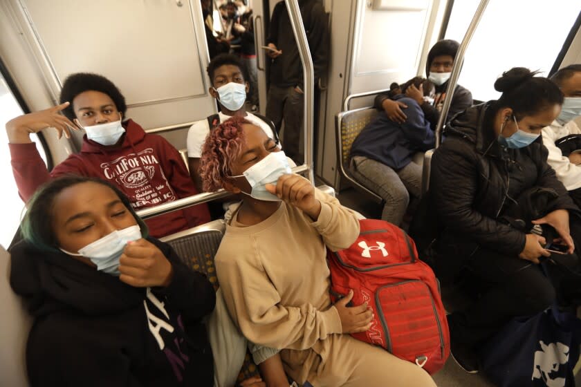 LOS ANGELES, CA - APRIL 21, 2022 - - Palisades Charter High School students ride the MTA Expo line after school let out in Los Angeles on Thursday, April 21, 2022. Masks will again be required on all public transit within Los Angeles County, including buses, trains, taxis and ride-hailing service vehicles, under a new COVID-19 health order that will take effect Friday, April 22, 2022. (Genaro Molina / Los Angeles Times)