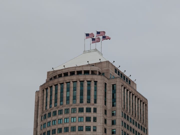 A photo of a building in Detroit with four American flags on top of it, taken with the Honor Magic 6 RSR.