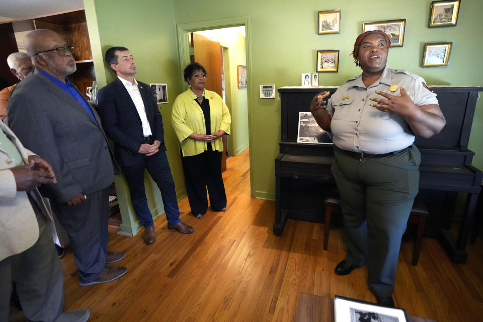 U.S. Rep. Bennie Thompson, D-Miss., left, U.S. Transportation Secretary Pete Buttigieg, second from left, Reena Evers-Everette, center, listen as Keena Graham of the National Park Service, right, speaks about the home of assassinated civil rights leader Medgar Evers, Friday, June 21, 2024, in Jackson, Miss. The house, the Medgar and Myrlie Evers National Monument, was one of the stops Buttigieg made as he spent Thursday and Friday in Mississippi, promoting projects that will be helped or will be receiving money from a federal infrastructure act. (AP Photo/Rogelio V. Solis, Pool)