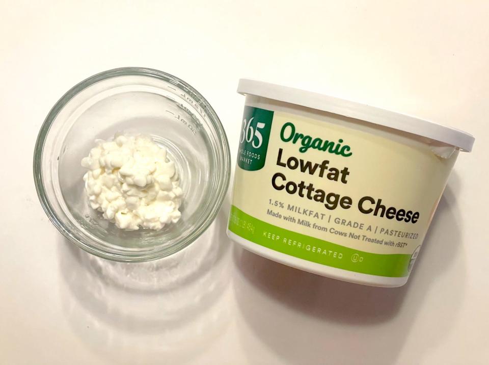 365 cottage cheese in a glass bowl next to a tub of 365 cottage cheese