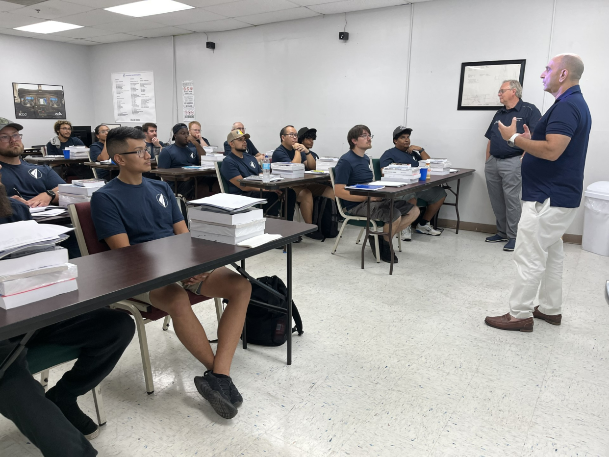 Students listen during an Amazon evening Airframe & Powerplant maintenance training class this week.