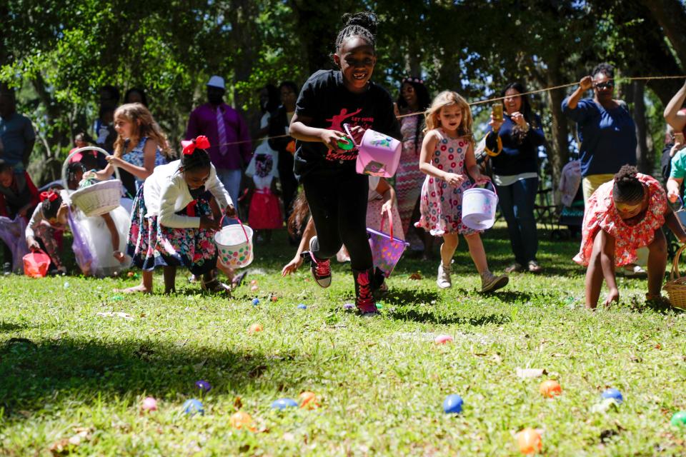 Dallyce Humphries, 7, runs to grab Easter eggs during Tallahassee's 60th annual Easter egg hunt at Myers Park Sunday, April 21, 2019. 