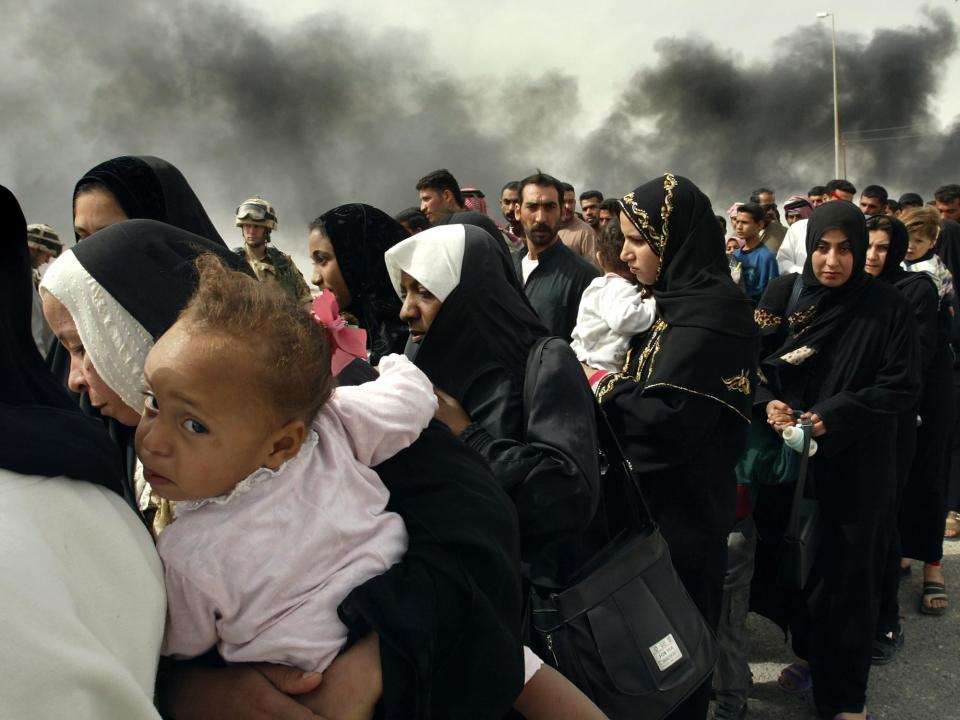 FILE - In this Sunday, March 30, 2003 file photo made by Associated Press photographer Anja Niedringhaus, Iraqi women line up for a security check by British soldiers on the outskirts of Basra, as they try to flee from this southern Iraqi town. Niedringhaus, 48, an internationally acclaimed German photographer, was killed and AP reporter Kathy Gannon was wounded on Friday, April 4, 2014 when an Afghan policeman opened fire while they were sitting in their car in eastern Afghanistan. (AP Photo/Anja Niedringhaus, File)