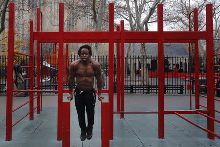 A man exercises in a park during a bout of unseasonably warm weather in Manhattan, New York December 14, 2015. REUTERS/Lucas Jackson