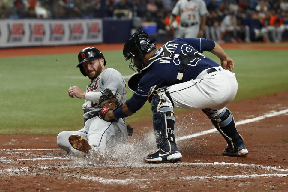 Detroit Tigers' Robbie Grossman, left, beats the tag of Tampa Bay Rays catcher Francisco Mejia while sliding safely home during the third inning of a baseball game Friday, Sept. 17, 2021, in St. Petersburg, Fla. (AP Photo/Scott Audette)
