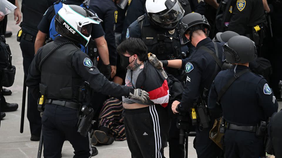 Police detain a pro-Palestinian demonstrator as they clear an encampment after protesters surrounded the Physical Sciences Lecture Hall at the University of California, Irvine, Wednesday. - Patrick T. Fallon/AFP/Getty Images