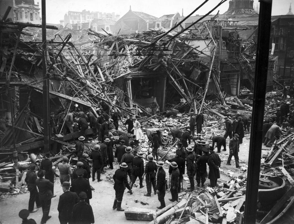 Rescue workers help pull victims from ruins of a building hit by a German V-1 "flying bomb," July 1944.