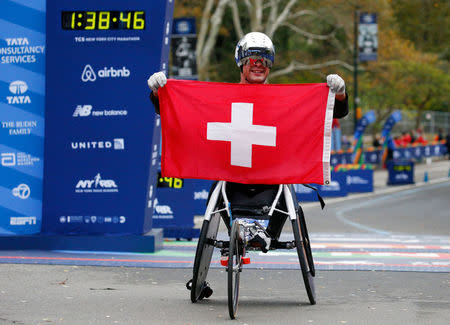 Marcel Hug of Switzerland celebrates at the finish line of the New York City Marathon after winning the wheelchair race in Central Park in New York, U.S., November 5, 2017. REUTERS/Brendan McDermid?