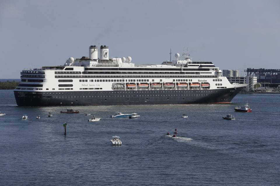 The cruise ship Rotterdam turns as it prepares to dock at Port Everglades, Thursday, April 2, 2020, in Fort Lauderdale, Fla. A cruise ship that has been floating at sea with coronavirus patients aboard for two weeks after being turned away from South American ports was finally allowed to dock in Florida. The Zaandam and a sister ship sent to help it, the Rotterdam, were both given permission to disembark passengers after days of negotiation with local officials who feared it would divert needed resources from a region that has seen a spike in virus cases. (AP Photo/Wilfredo Lee)