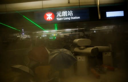 Protest at Yuen Long MTR station, the scene of an attack by suspected triad gang members a month ago, in Hong Kong